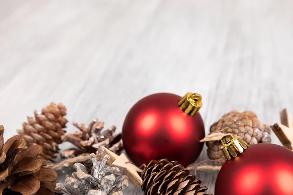 Closeup Red Christmas Tree Ornaments Pinecones Wooden Surface — Stock Photo, Image