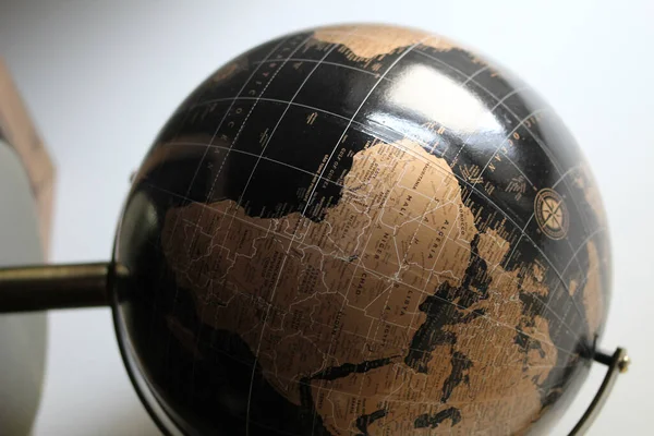 Vertical Shot Black Gold World Globe Isolated Blurred Background — Stock Photo, Image