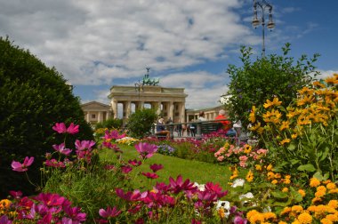 Berlin, Almanya 'da güneşli bir günde Brandenburg Kapısı önünde güzel bir halk bahçesi fotoğrafı.