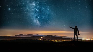 A closeup shot of a Caucasian man looking at the landscape in Germany at night