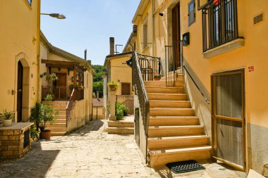A narrow street between the old houses of Ruvo del Monte in the mountains of Basilicata region