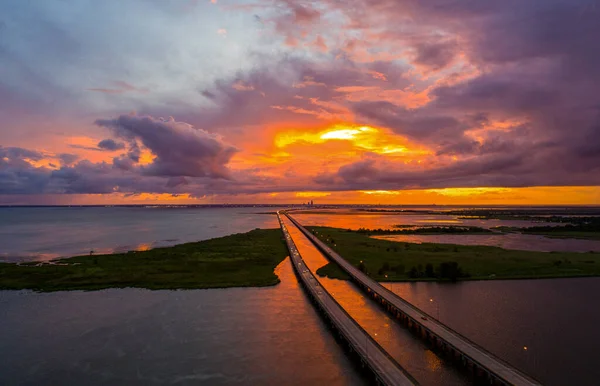 An aerial shot of the Interstate 10 highway at sunset passing through Gulf Coast of Alabama, United States