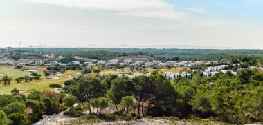 Panoramic wide-angle view of Las Colinas luxury residences and golf course landscape. Costa Blanca, Alicante, Spain clipart