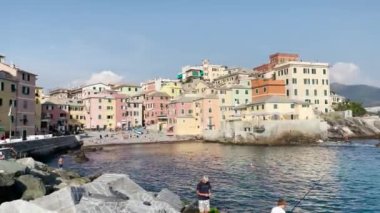 İtalya 'nın Boccadasse bölgesinde güneşlenen bir sürü insan var.
