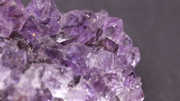 光沢のあるガラスのような表面を持つ神秘的な紫色の結晶の閉鎖 — ストック動画