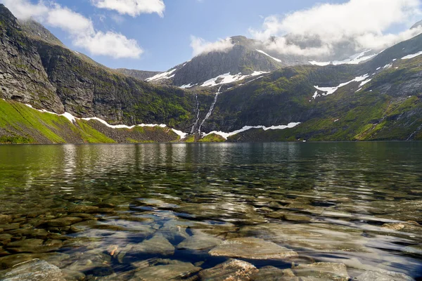 Klidné Jezero Průzračnou Vodou Obklopeno Skalnatými Horami Pokrytými Sněhovými Skvrnami — Stock fotografie