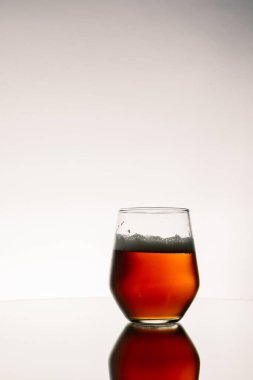 Masada yansıması olan dikey bir bardak bira.
