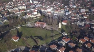 Güneşli bir günde evlerle dolu bir kasabanın hava görüntüsü.