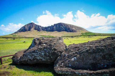 A view of Easter Island with Moai monolithic human figure in background of hills