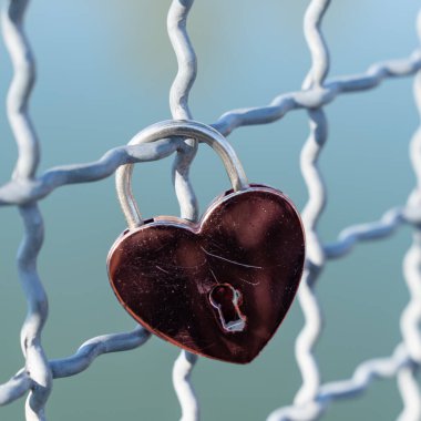 Kalp şeklinde kırmızı bir kilidin yakın plan çekimi.