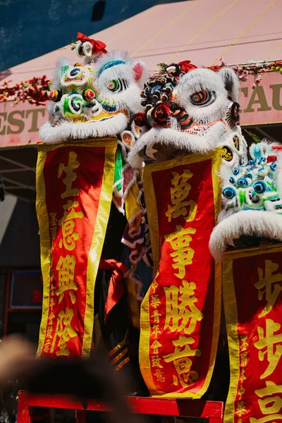 a vertical shot of dragon dancing in the middle of Chinatown in Melbourne.