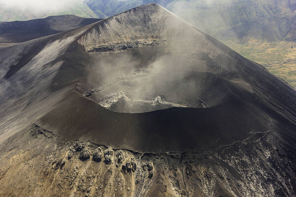 Stunning bird's eye view closeup photography of a smoking volcano caldera in the Serengeti, Tanzania.