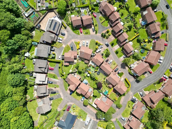 An aerial top shot of a housing estate with green surroundings