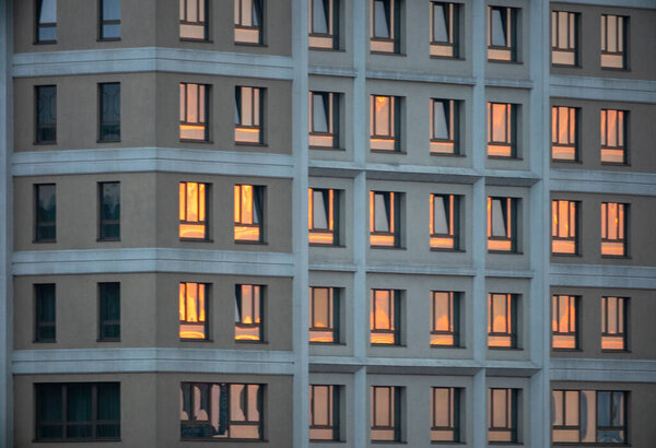 The illuminated windows of the International Hotel at sunset in Iasi, Romania