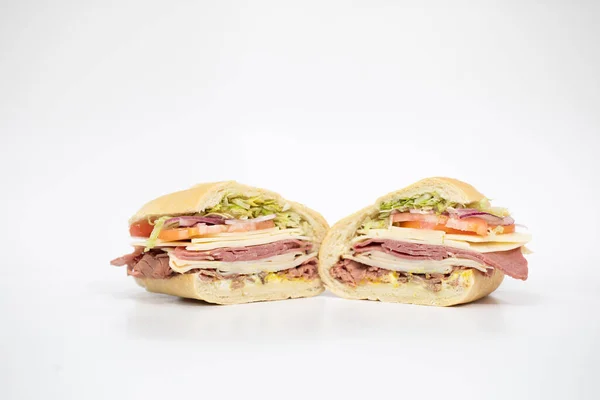 Italian Sub Sandwich Sliced Half Portraying All Its Ingredients White — Stock Photo, Image