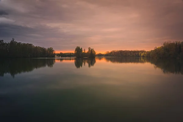 Vacker Solnedgång Över Sjön Omgiven Träd Som Speglar Sig Vattnet — Stockfoto