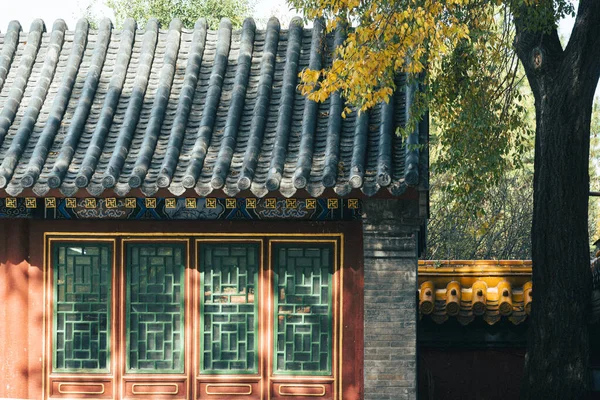 A beautiful view of a Chinese old building in a park with trees