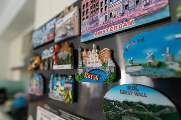 A collection of fridge magnet souvenirs from Paris, Holland, Amsterdam and China