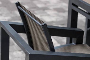 Avlunun yüksek açılı görüntüsü. Sıradan siyah bir pelerin. Açık hava mobilyası.