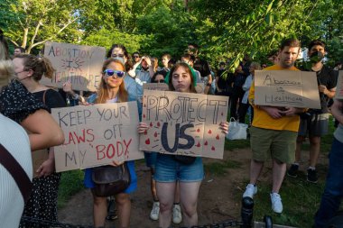 Bir grup protestocu, Anayasa Mahkemesi 'nin Roe-Wade davasını geri çekmesi üzerine ellerinde karton levhalar tutuyorlar.