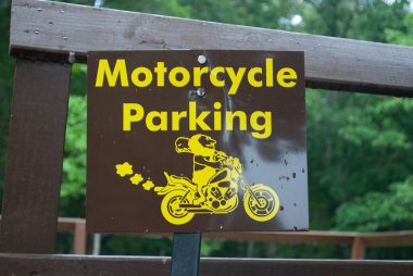 Bulanık arka planda motosiklet parkına dair bir yakın çekim.