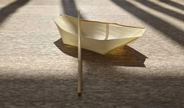 A closeup shot of a miniature boat under the sunlight