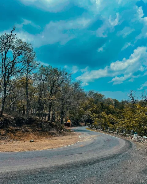 Tiro Vertical Uma Estrada Asfalto Molhada Sob Céu Azul Que — Fotografia de Stock