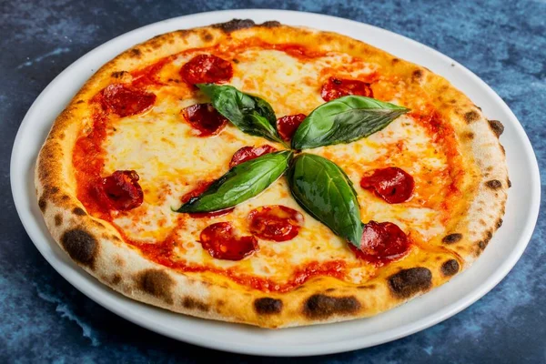 Closeup Shot Pepperoni Pizza Salami Basil Leaves Blue Table — Stock Photo, Image