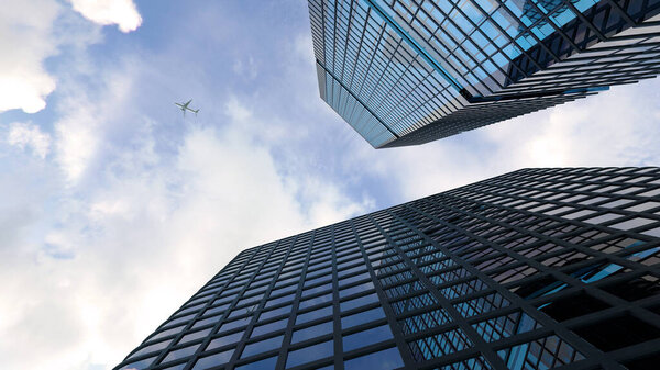 A low angle of modern skyscrapers against the sky and a plane