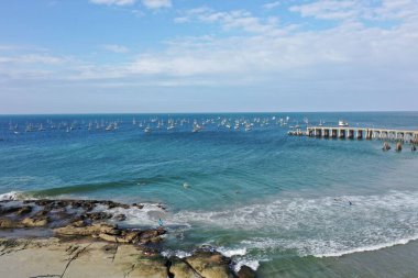 Parlak bir gökyüzünün altındaki deniz manzarası.
