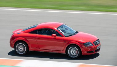 first generation red Audi TT running on the Valencia racing circuit clipart