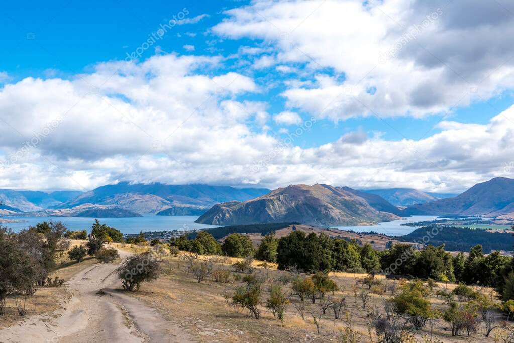 A field and a trail in the Mt Iron Track in Wanaka, Otago, South Island, New Zealand