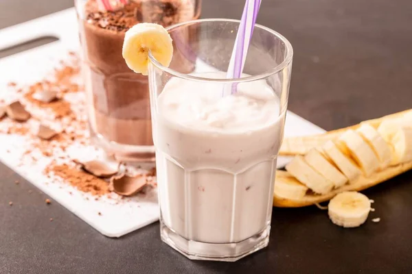 A closeup of milk shake with banana and ice cream