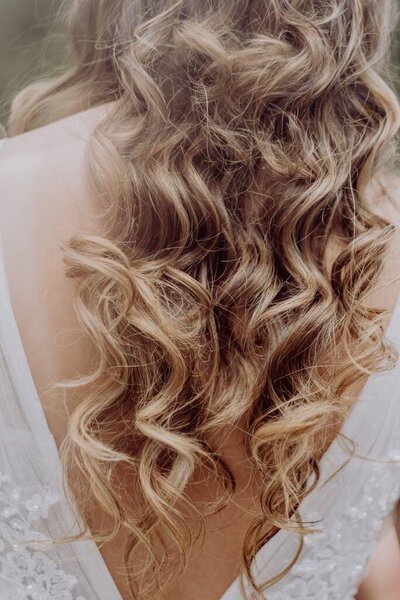 A bride with long beautiful curly hair