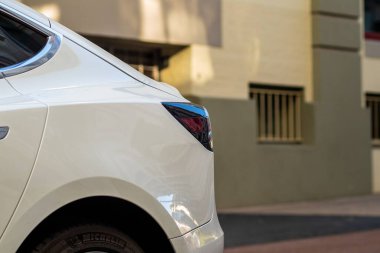 Beyaz bir arabanın arka kısmı ve kırık ışığı.