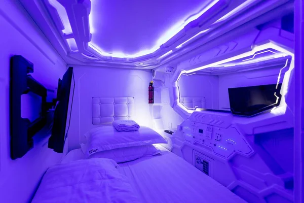 An Interior of a creative illuminated capsule hotel