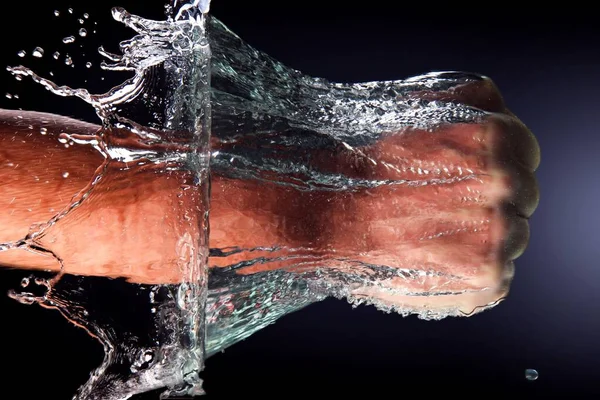 Крупный План Мужского Кулака Пробивающего Воду Тёмном Фоне — стоковое фото