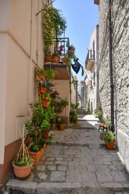 A narrow street between the old houses of Pietragalla, a village in the Basilicata region, Italy.