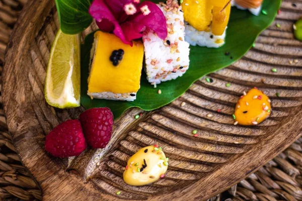 Closeup Set Sushi Rolls Wooden Plate Fruit Flower Garnish Sauce — Stock Photo, Image