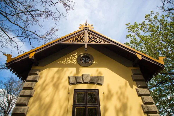 A low angle shot of an old yellow train conductor\'s house in Hungary