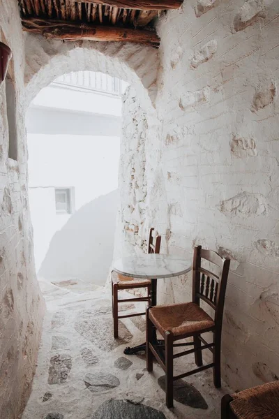 建筑物之间狭窄的通道和一张有椅子的桌子 — 图库照片