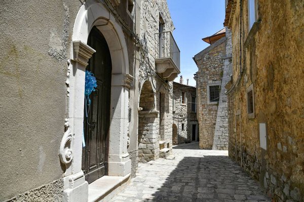 A narrow street between the old houses of Pietragalla, a village in the Basilicata region, Italy.