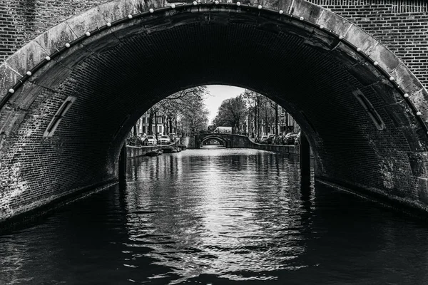 Protékající Řeka Pod Kamenitým Obloukem Obklopená Rostoucími Stromy Amsterdamu Černé — Stock fotografie