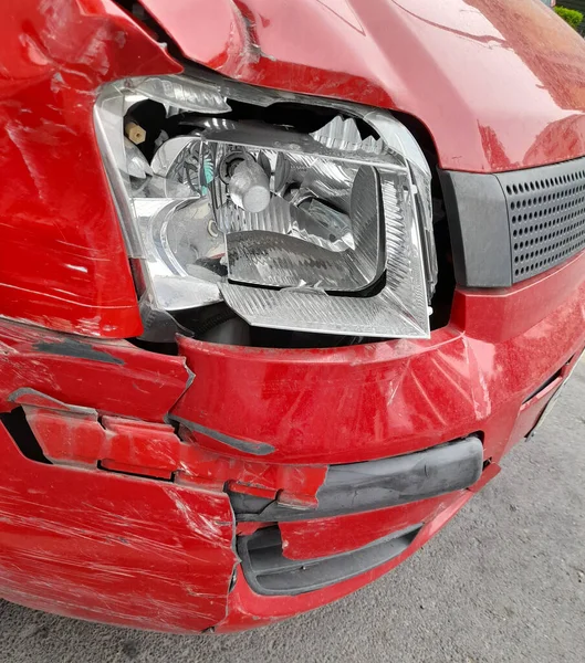 Dükkandaki kırmızı bir arabanın kırık farları.