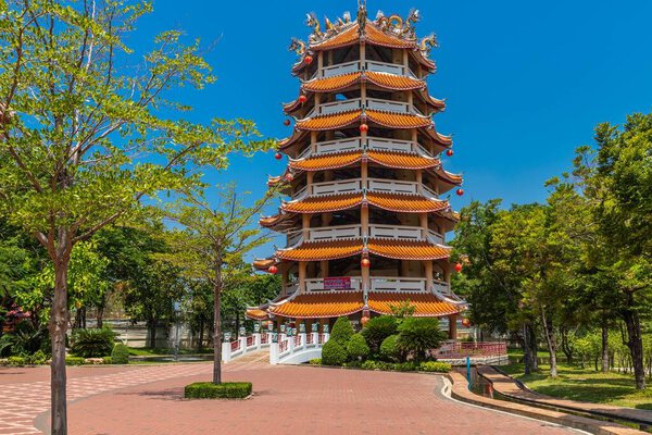 A beautiful view of a temple with a garden on a sunny day in thailand