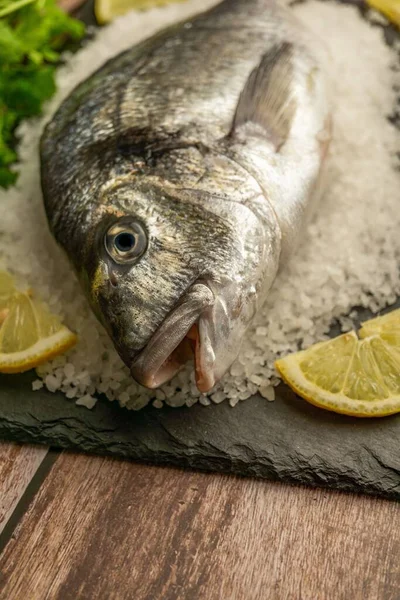 Close Fresh Sea Bream Salt Slices Lemon Black Slate Wooden — Stock Photo, Image