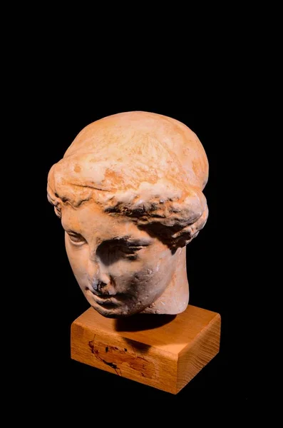 Head of the Ancient Greek Statue Isolated on a Black Background