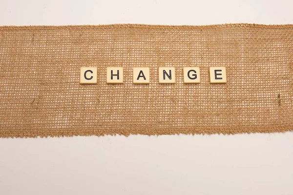Change Concept Letter Tiles Laid Hessian Jute Cloth Isolated White — Stock Photo, Image