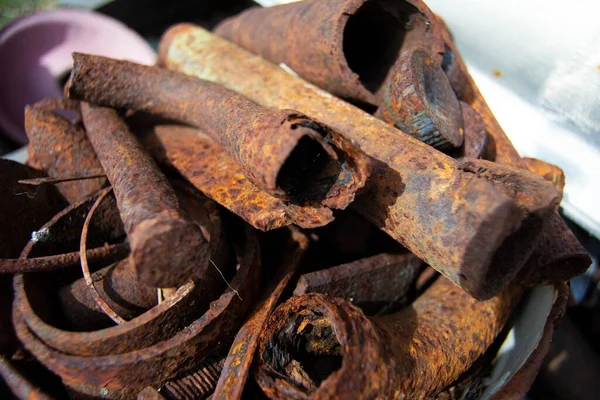 Diverse old rusty scrap metal from different items close-up. Collection and delivery of scrap metal. Abstract Background. Soft focus, defocus.