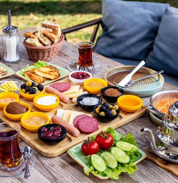 Traditional Turkish Breakfast Platter Cups Tea Served Wooden Table Outdoors — Stock Photo, Image